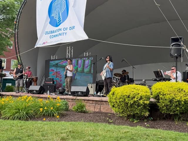 Gumbo on the amphitheater stage at a Danbury community festival